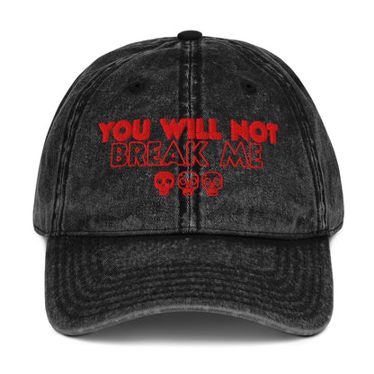  a black acid washed denim cap, it says "You will not break me" in red embroidered text with 3 skulls. This is a quote from Dungeon Crawler Carl, it was designed by Starlit Prose Bookish Merch Australia