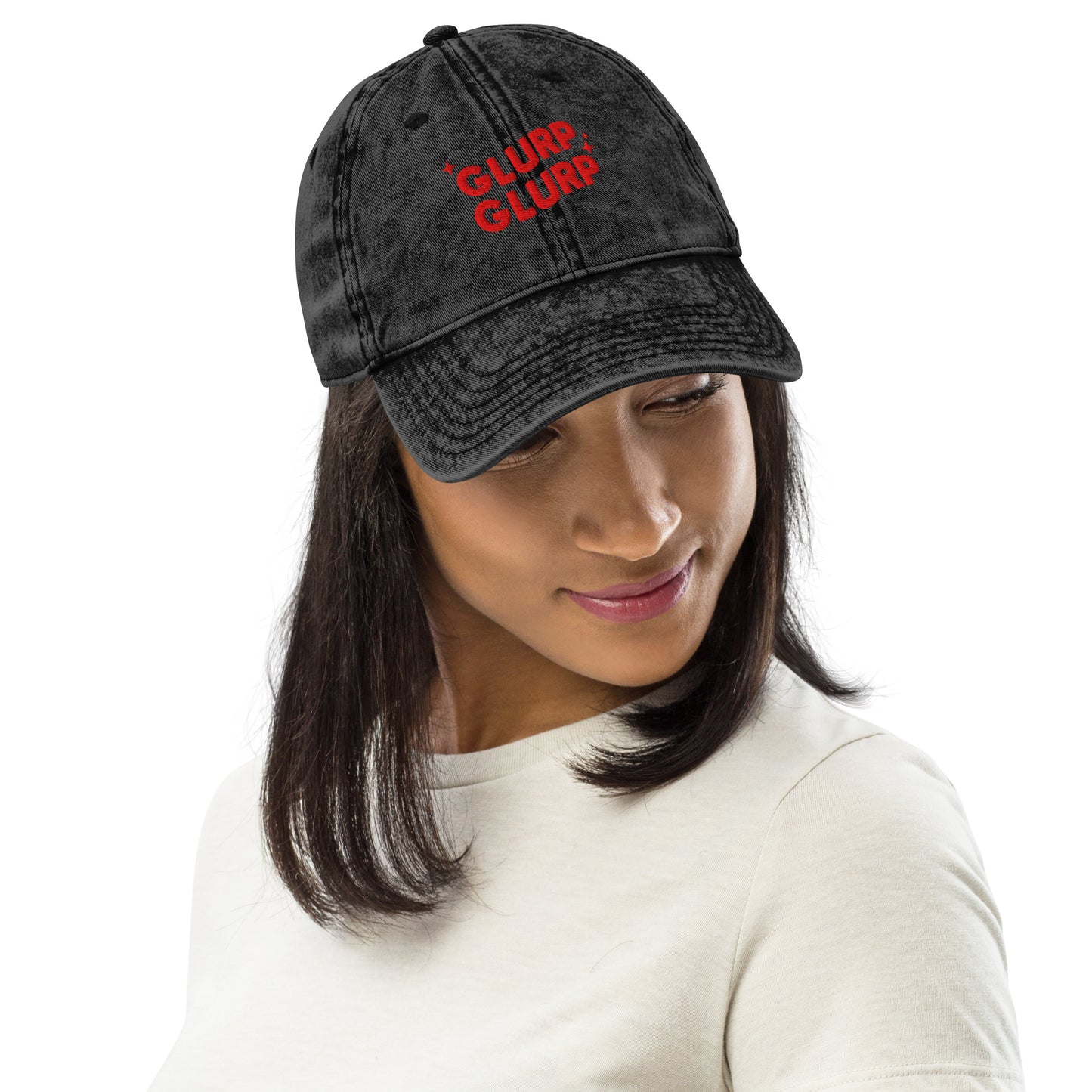 A woman wearing A black acid-wash baseball cap with 'GLURP GLURP' embroidered in red on the front, a quote from Dungeon Crawler Carl book series, shown against a plain white background. Designed by Starlit Prose Bookish Merch Australia