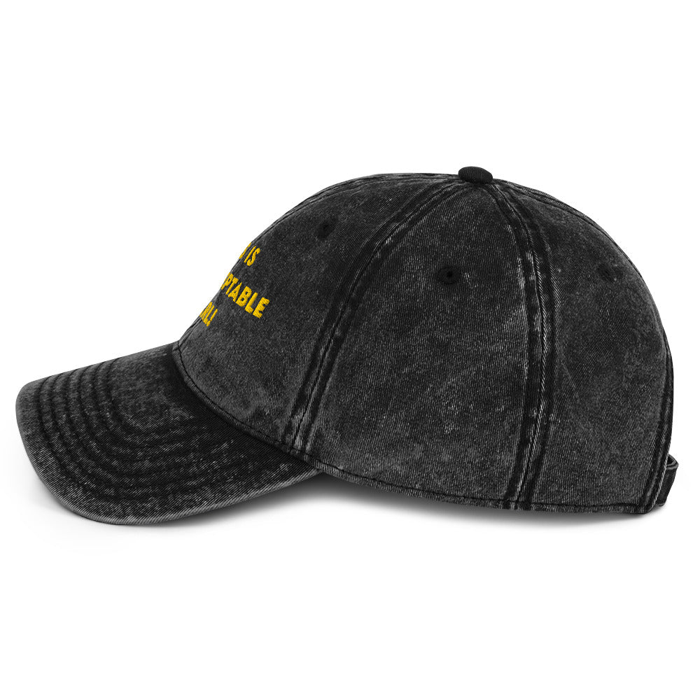 Side view of A washed black denim baseball cap that says "This is unacceptable Carl" in yellow embroidered text. Quote from Princess Donut of Dungeon Crawler Carl book series. Designed by Starlit Prose Bookish Merch Australia
