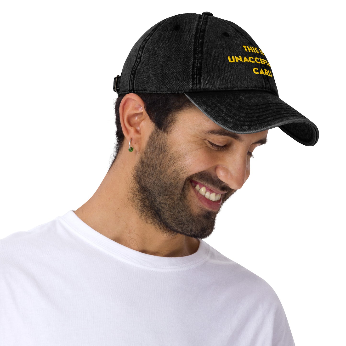 Side view of a Man wearing A washed black denim baseball cap that says "This is unacceptable Carl" in yellow embroidered text. Quote from Princess Donut of Dungeon Crawler Carl book series. Designed by Starlit Prose Bookish Merch Australia