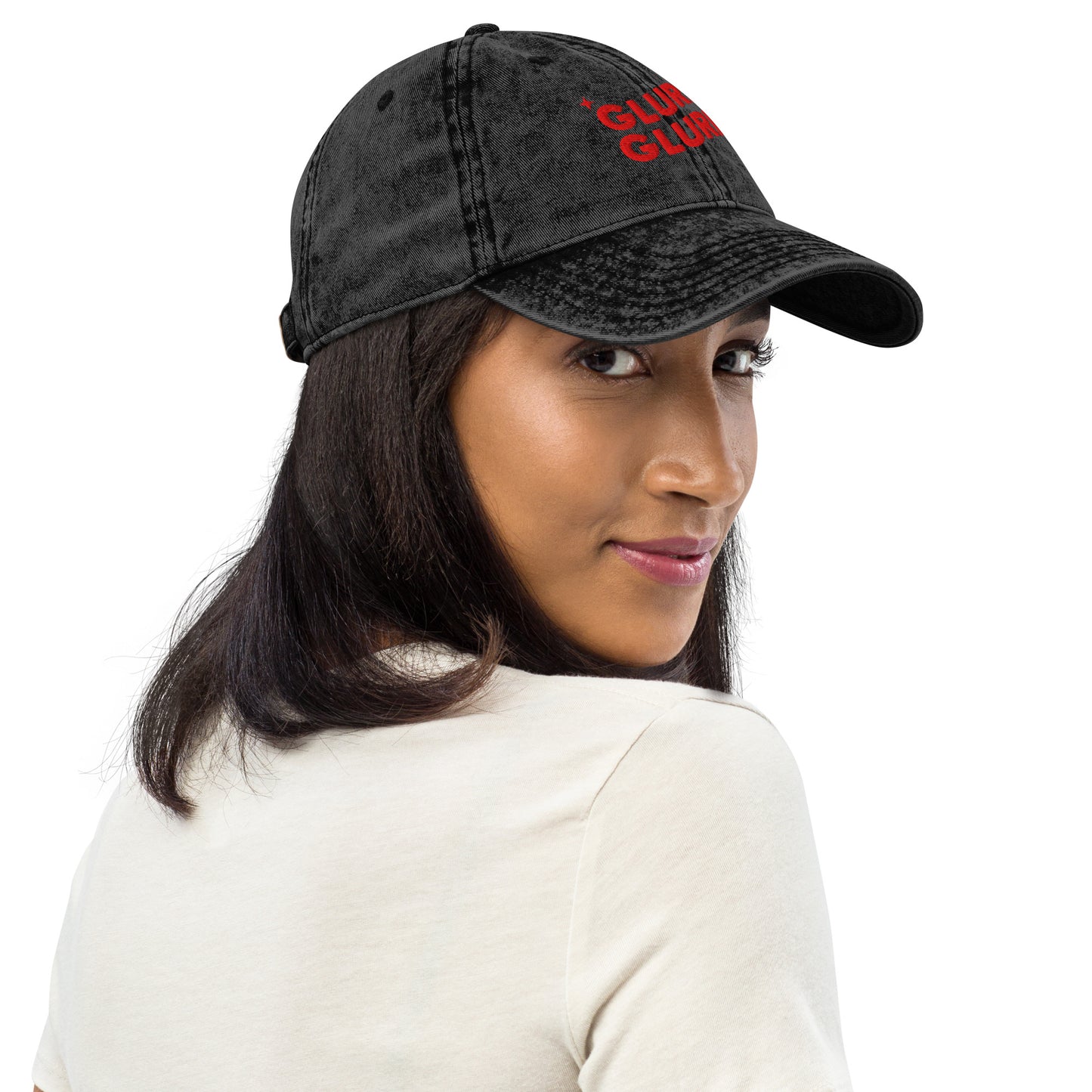 Side view of a Woman wearing A black acid-wash baseball cap with 'GLURP GLURP' embroidered in red on the front, a quote from Dungeon Crawler Carl book series, shown against a plain white background. Designed by Starlit Prose Bookish Merch Australia