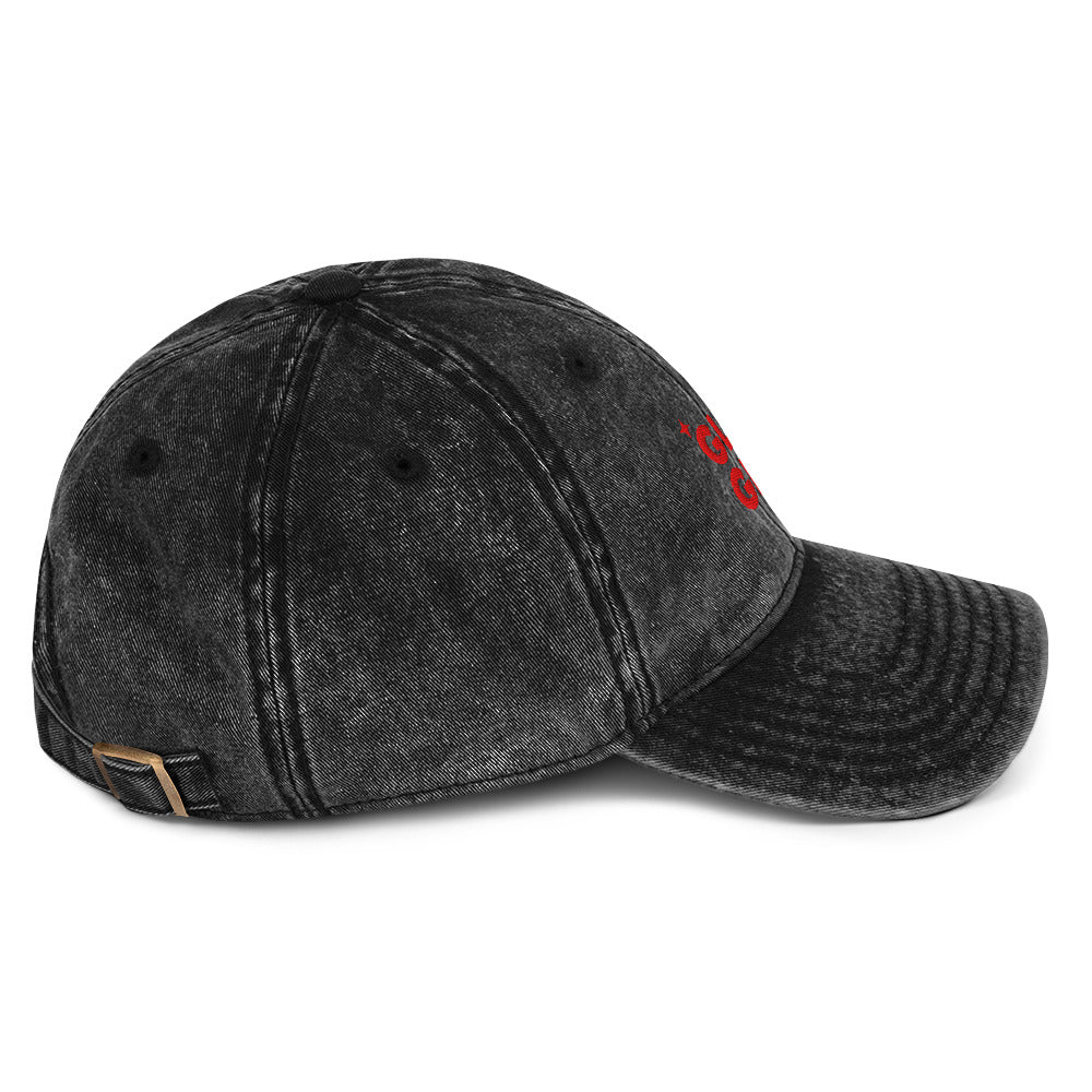 Side view of A black acid-wash baseball cap with 'GLURP GLURP' embroidered in red on the front, a quote from Dungeon Crawler Carl book series, shown against a plain white background. Designed by Starlit Prose Bookish Merch Australia