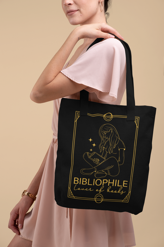 Woman in pink dress holding the Bibliophile Tarot Card Bookish Tote Bag 